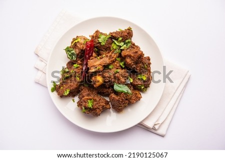 Sukha mutton or chicken, dry spicy Murgh or goat meat served in a plate or bowl