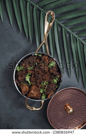 Sukha mutton or chicken, dry spicy Murgh or goat meat served hot,  mutton fry, special hot spicy traditional dish. Buffalo roast, meat pepper fry. Top view South Indian non veg food side dish Rice.