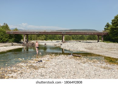 Sukhumi / Abkhazia - August 2, 2019: Man Bathing In Shallow River With Dog