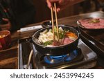 Sukiyaki Japanese hotpot with beef and vegetables cooking on stove