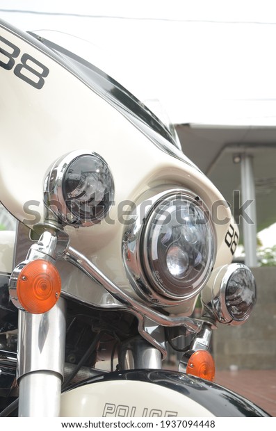 Sukoharjo, Central Java, Indonesia - 25\
February 2021: Black and White Harley Davidson Electra Police noise\
or blurring photos park near the lake during the\
day