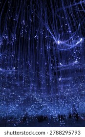 Sukoharjo, Central Java, Indonesia, December 11th 2025 - An immersive indoor light installation with a massive number of white-blue lamps hanging on thin cables, creating a magical fairy tale field of stars.
