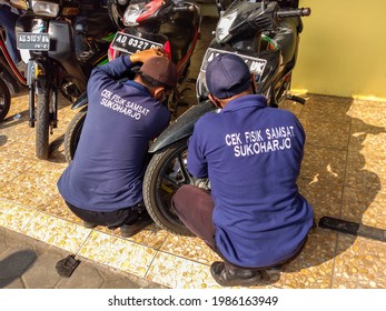 Sukoharjo, Indonesia - May 27, 2021: Samsat Officers Inspect Vehicles To Complete Vehicle Tax Payment Activities At The Samsat Office. Government Public Services.