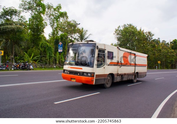 Sukoreno Bend,\
Sunday, April 10, 2011. A cargo bus belonging to the Santoso bus\
company passes the Sukoreno\
bend.