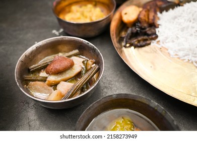 SUKTO a traditional Bengali Food or Dish which is sweet-bitter in taste is served on a brass bowl isolated on a dark background. Bengali authentic Cuisine - Shutterstock ID 2158273949