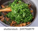 Sukuma wiki is a dish made with collard greens, known as sukuma, cooked with onions and spices, served with ugali in Tanzania, Kenya, Uganda East Africa