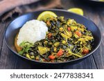 Sukuma wiki is an East African dish made with collard greens, known as sukuma, cooked with onions and spices