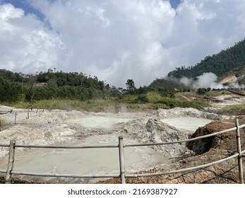 
Sulfur Crater With White Smoke Billowing Around