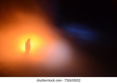 Sulfur miner with torch in the Middle of SO2 gas in Kawah Ijen (Volcano). Every day 2 person assigned to control the blue fire in sulfur mine in Kawah Ijen so that it can be taken easily by miner. 