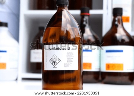 sulfuric acid in glass, Hazardous chemicals and symbols on containers in factory or laboratory 