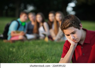 Sulking Male Caucasian Teen With Face In Hands