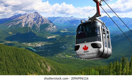 Sulphur Mountain Gondola on a blue sky with snow peaked Rocky Mountains background (Banff. Alberta. Canada) - Shutterstock ID 2096996116