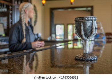 Sulphur Springs. Texas, USA - June 24, 2020 - Blonde Apprentice Witch Prepares For Halloween At The Bar For A Local Country Club.