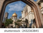 Sultan Mosque Masjid entrance gate against blue sky in the Kampong Glam district, Bugis, Singapore. famous travel destination or religion landmark in Arab area.