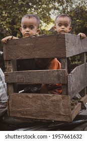 SUMATRA, INDONESIA - Feb 10, 2021: Children At The Back Of A Motorbike  Twins  Familly Going Around 