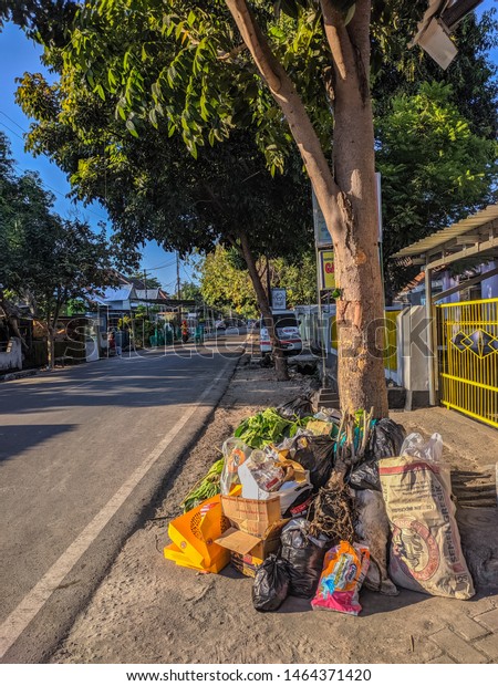 Sumbawa Besar indonesia Monday June\
29 2019, every morning the janitor takes garbage on each side of\
the city road and is taken in a yellow garbage\
truck