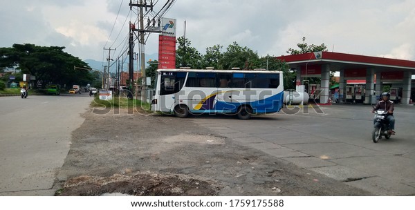 Sumedang, Indonesia - 16 April 2020 : The\
employee bus is parked in front of the Pertamina gas station on the\
West Java Sindangpakuon\
highway