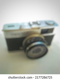 SUMENEP, INDONESIA – AUGUST 12, 2020: Defocused abstract background of an old camera or commonly called an analog camera branded olympus trip 35 in Sumenep-Madura, Indonesia on August 12th 2021.