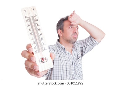 Sumer heat and heatwave concept with man holding thermometer isolated on white