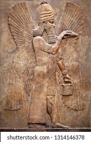 Sumerian Wall Relief Of Winged Genius From Mesopotamia. Carving Panel With Babylonian God, Art Of Ancient Babylon. Monument Of Past Civilization Culture. History Of Iraq And Mesopotamia Theme.