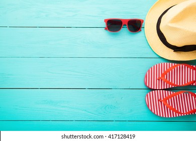 Summer accessories on blue wooden floor. Top view and copy space, picturesque. Mock up and fashion and beauty.  - Powered by Shutterstock