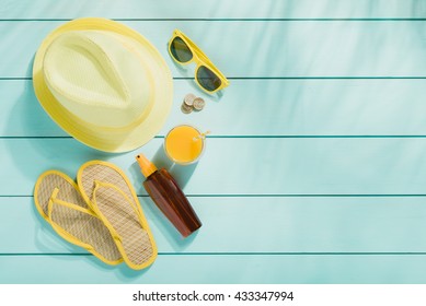Summer accessories on wooden background top view