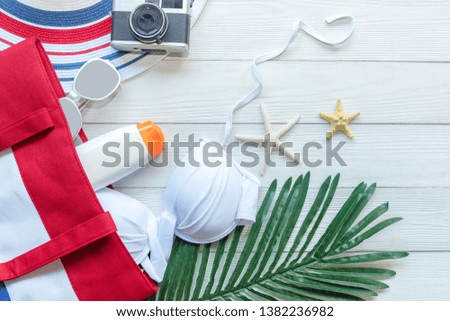 Summer  accessories, white bikini , camera go to travel plan holiday vacation in the beach. Tropical sea. Unusual top view. Travel and Summertime Concept.