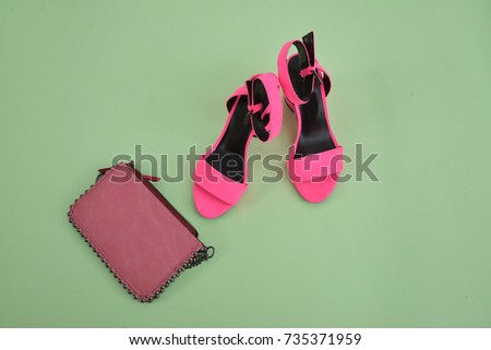 Summer accessories:pink high heel with leather bag –green background