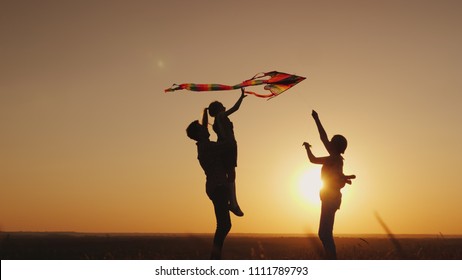 Summer activity - the family plays carefree with a kite