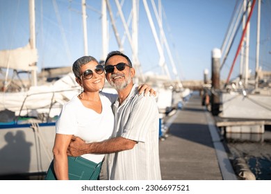 Summer Adventure. Cheerful Mature Spouses Embracing Posing At Marina With Luxury Yachts And Sailboats Outside, Standing At Pier On Sunny Day Smiling To Camera. Spouses Advertising Sea Cruise - Powered by Shutterstock
