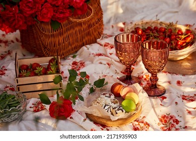 Summer Aesthetic Pink Picnic With Tablecloth Marshmallows, Macaroons, Peas, Strawberries, Glasses Of Wine, Cherries Among Pink Roses In The Garden. Romantic Dinner.