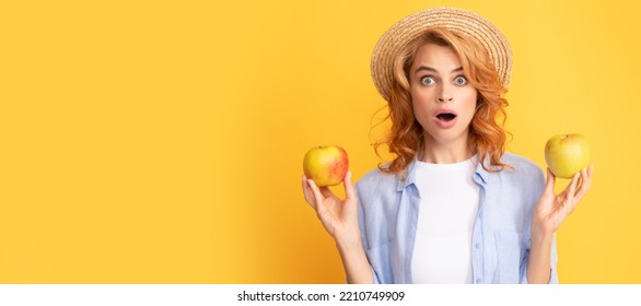 Summer Apple. Shocked Young Woman Curly Hair In Summer Straw Hat With Apple, Detox. Woman Isolated Face Portrait, Banner With Mock Up Copy Space.