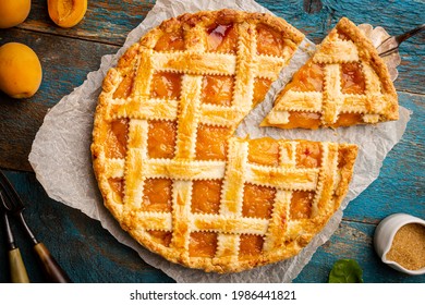 Summer apricot or peach pie homemade on blue wooden background, top view. Delicious fruit dessert. Fruit cake. Copy space. - Powered by Shutterstock