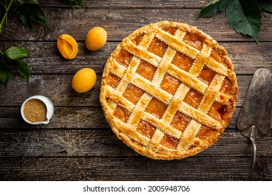 Summer apricot or peach pie homemade on wooden background, top view. Delicious fruit dessert. Fruit cake. Copy space. - Shutterstock ID 2005948706