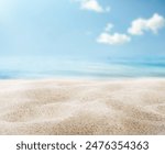 summer background of beach sand in the foreground and sea in the background