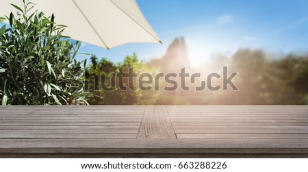 Summer background with empty wooden table for a concept