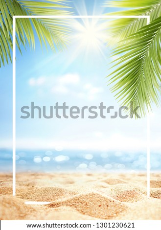Summer background with frame, nature of tropical golden beach with rays of sun light and leaf palm. Golden sand beach close-up, sea,  blue sky, white clouds. Copy space, summer vacation concept.