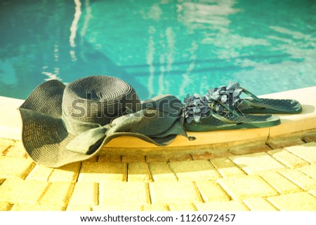summer background with hat, flip flops, near the swimming pool
