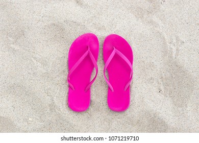 Summer background Pink Flip flops on the sand fun beach day relax and traveling sea concept