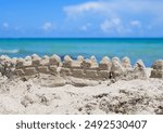 Summer background. Sand castle. Summer vacation concept. Sand castle at beach. Sandcastle on the seaside. Summertime vacation.