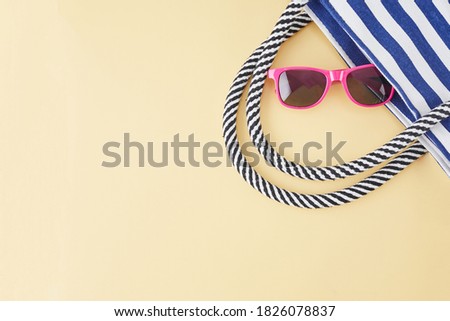 Summer background with straw beach hat, sunglasses, bag and flip flops. Summer travel concept.