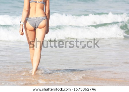 Summer background with woman in striped swimsuit