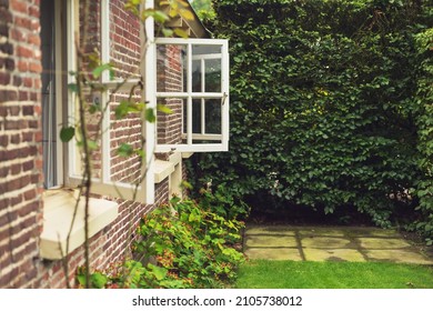 Summer Backyard With A Wall Of An Old Farmhouse With Opened Windows.