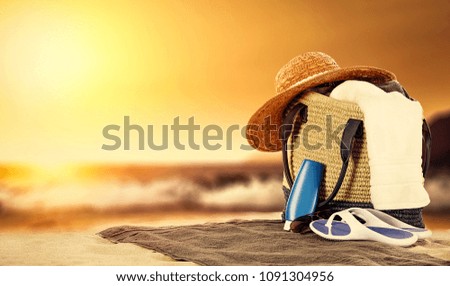 Summer bag on beach and sea landscape. Golden sunset time. Free space for your decoration. 
