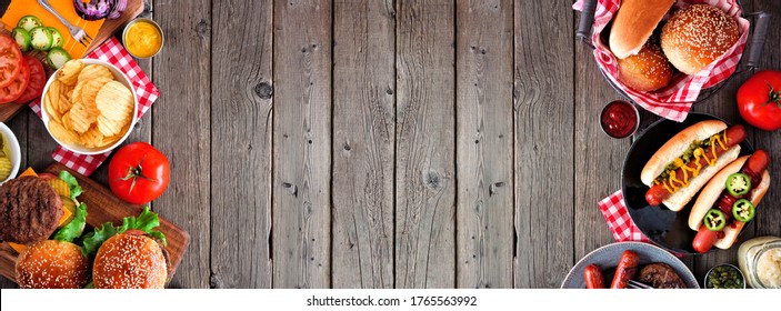 Summer BBQ food double side border with hot dog and hamburger buffet. Top view over a dark wood background. Copy space. - Powered by Shutterstock