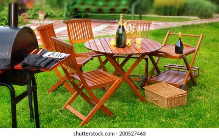 Summer BBQ Party Or Picnic In Backyard On Lawn. Tilt-shift Effect In Background.