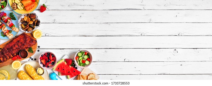 Summer BBQ Or Picnic Food Corner Border. Assortment Of Grilled Meat, Vegetables, Fruits, Salad And Potatoes. Overhead View Over A White Wood Background. Copy Space.