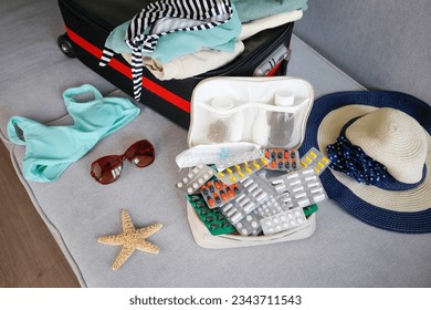 Summer beach accessories for your sea holiday and pills. Concept of medication required in journey. - Powered by Shutterstock