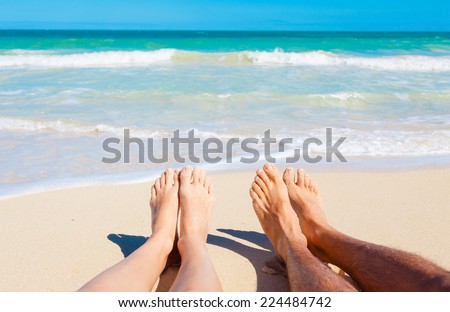 Summer and beach concept - couple lying on the beach