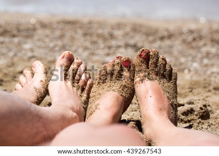 Summer and beach concept - couple lying on the beach. Couple feet on sand relaxing on the beach.